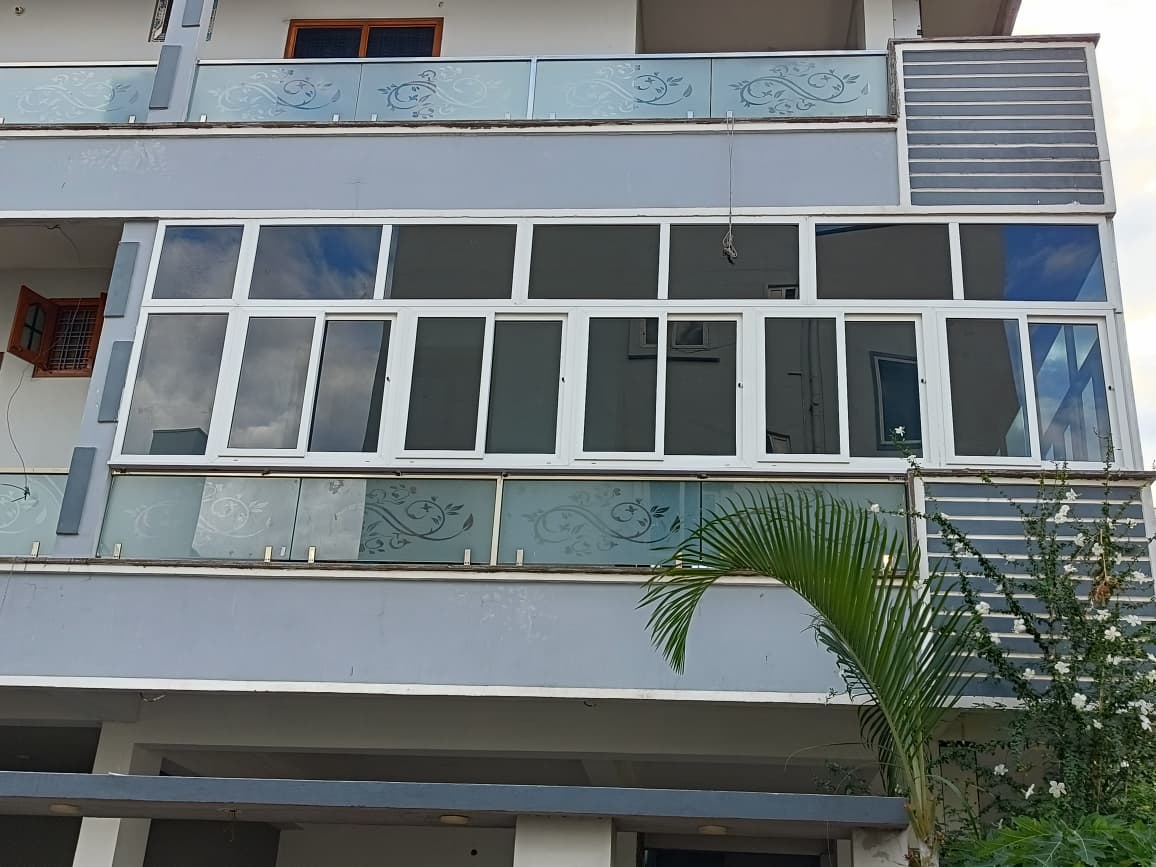 Full building facade with UPVC windows and etched glass balcony railings