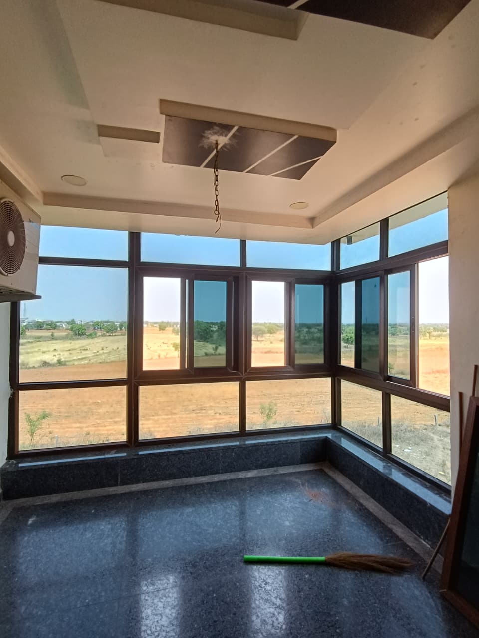 Corner-wrap floor-to-ceiling UPVC window enclosure