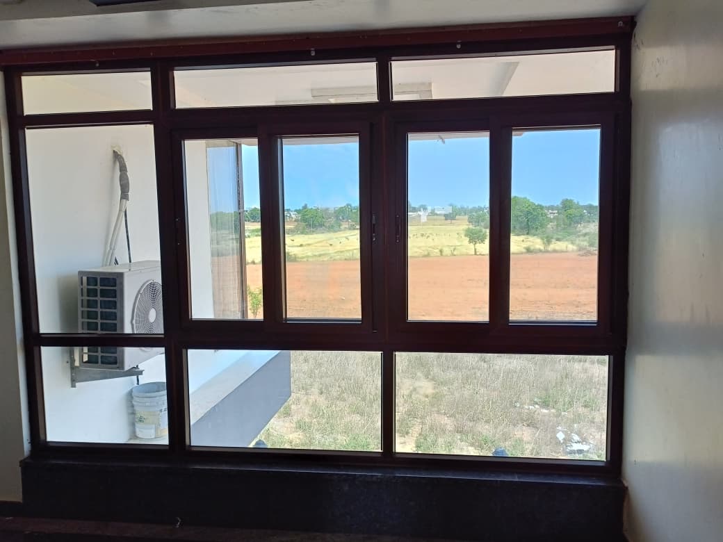Wide multi-panel UPVC sliding window with fixed toplights